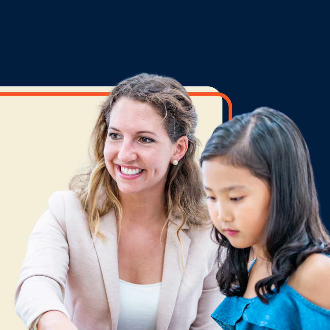 An image on a female teacher smiling, helping a female student